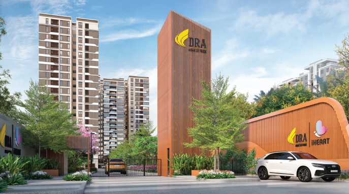 Entrance of DRA I Heart modern properties with tall towers, greenery, gated access, and a luxury car