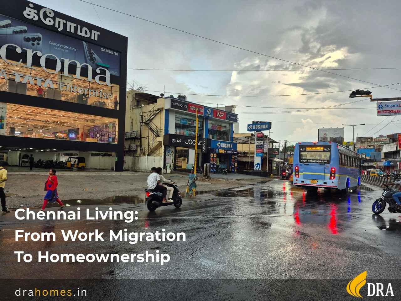 Chennai urban street scene work migration homeownership shift DRA Homes A wet city street in Chennai after rain with an MTC bus, commuters, commercial storefronts including Croma, and the text overlay reading Chennai Living: From Work Migration To Homeownership.